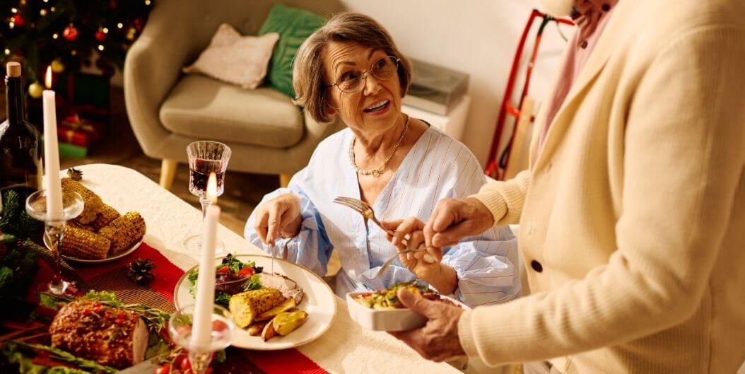 Elderly Couple Enjoying Holiday Dinner At Independent Living Facility