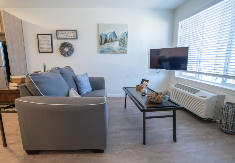 Living Room With Comfortable Seating and Natural Light at Independent Living Facility Living Room With Comfortable Seating and Natural Light at Independent Living Facility