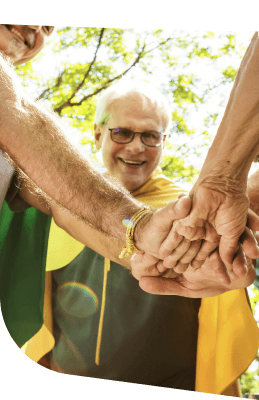 Group of Elderly Residents Joining Hands Together Outdoors in Independent Living Group of Elderly Residents Joining Hands Together Outdoors in Independent Living