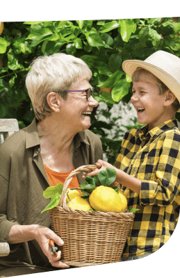 Elderly Woman and Grandchild Holding Basket of Fresh Lemons at Independent Living Facility Elderly Woman and Grandchild Holding Basket of Fresh Lemons at Independent Living Facility