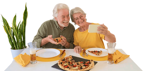 Elderly Couple Taking Selfie While Eating Pizza Together in Independent Living Elderly Couple Taking Selfie While Eating Pizza Together in Independent Living