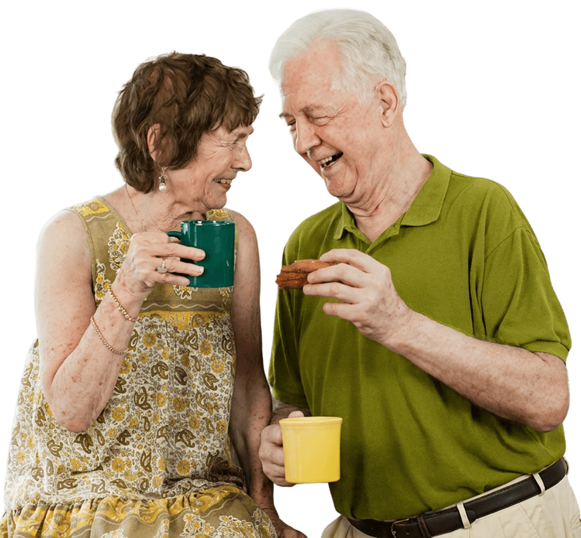 Elderly Couple Laughing Together over Coffee and Cookies in Independent Living Elderly Couple Laughing Together over Coffee and Cookies in Independent Living