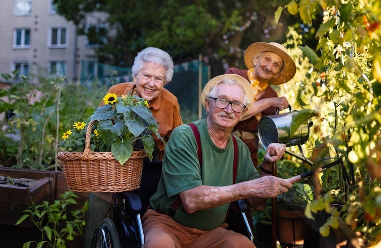 Three Elderly Friends Enjoying Wine and Conversation Outdoors in Independent Living