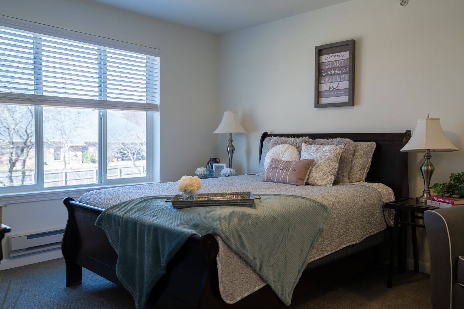 Restful Bedroom with Sleigh Bed and Bright Window in Our Independent Living Facility