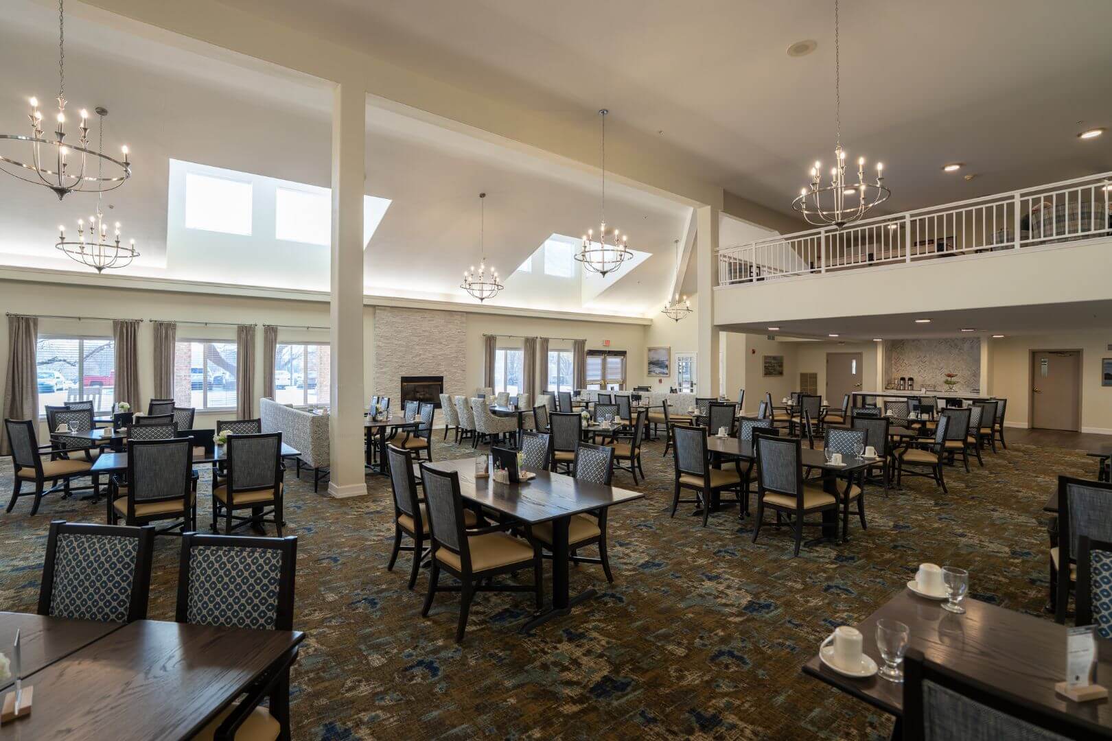 Spacious Dining Hall with Vaulted Ceiling and Chandeliers in Independent Living