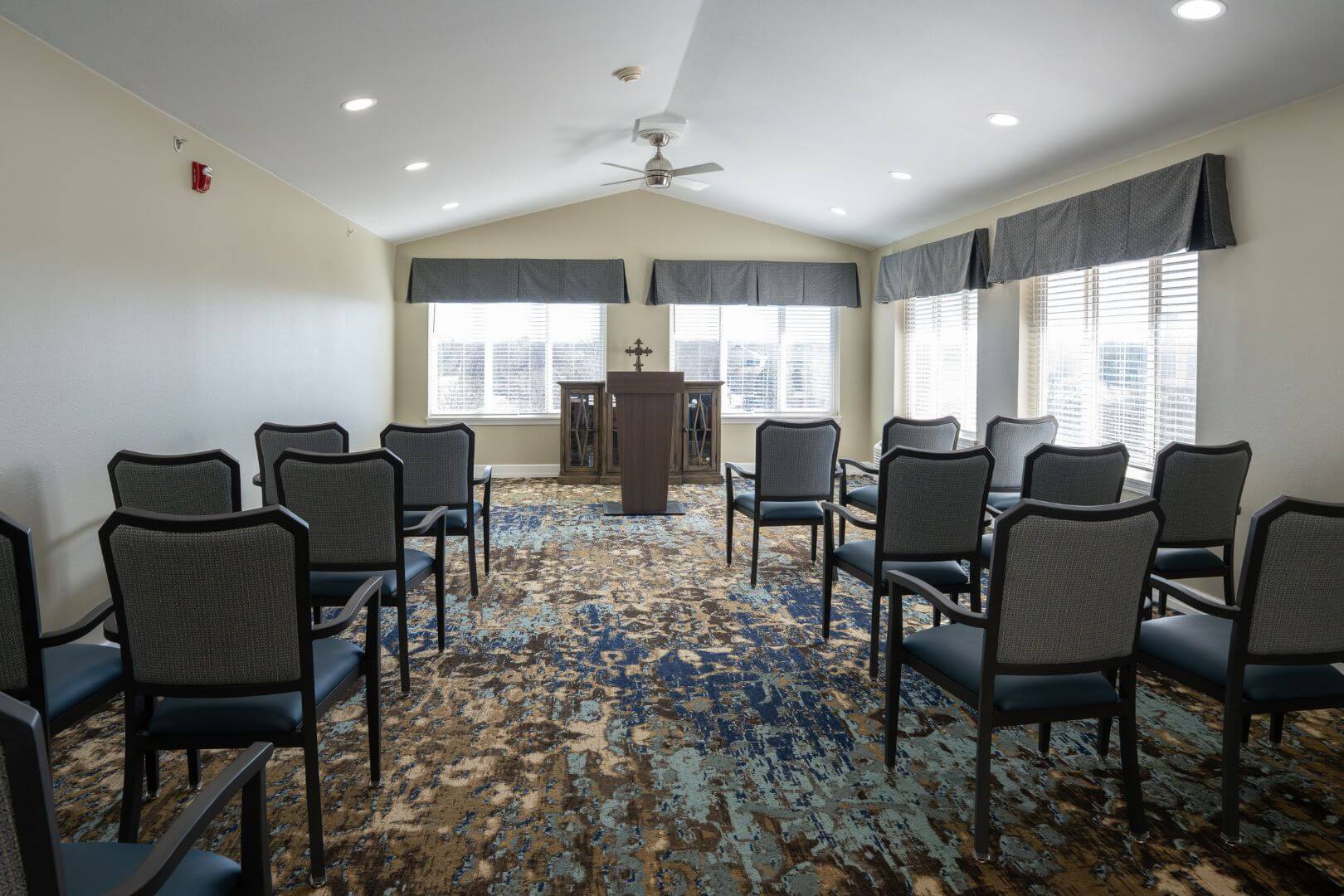 Peaceful Chapel Room with Arranged Chairs and Wooden Podium in Our Independent Living Community