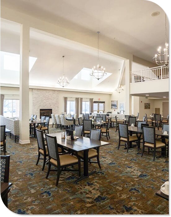 Vaulted Dining Hall with Chandeliers and Stone Fireplace at Independent Living Community Vaulted Dining Hall with Chandeliers and Stone Fireplace at Independent Living Community