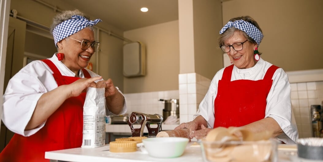 Elderly Women Baking Together in Community Kitchen at Independent Living Facility