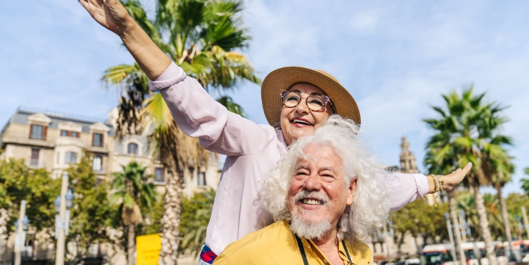 Elderly Couple Enjoying Sunny Outdoor Stroll at Independent Living Facility