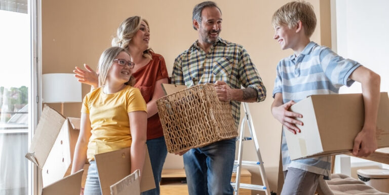 Family Carrying Moving Boxes into New Independent Living Facility Home